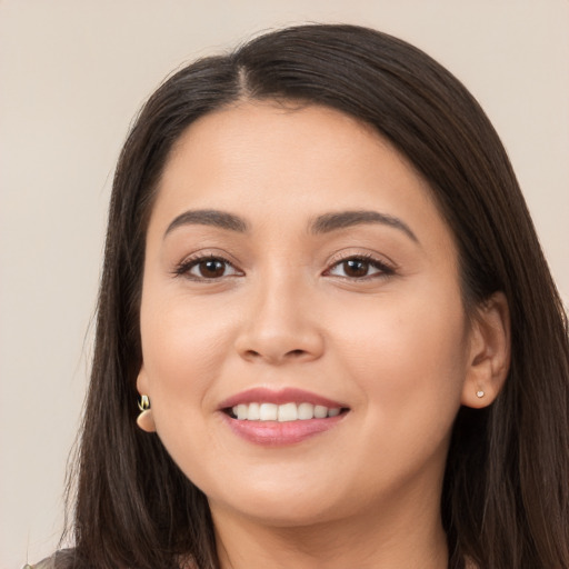 Joyful white young-adult female with long  brown hair and brown eyes