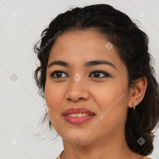 Joyful latino young-adult female with medium  brown hair and brown eyes