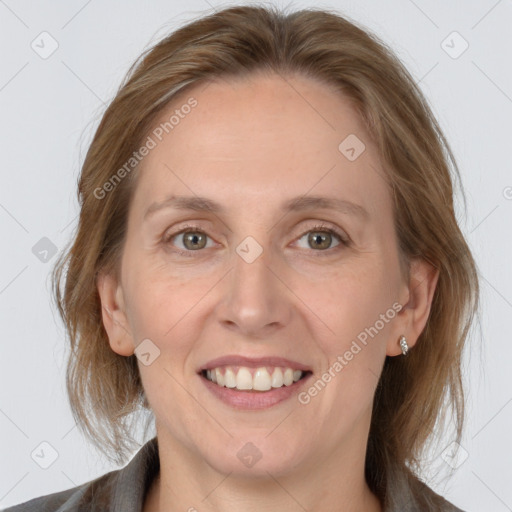 Joyful white adult female with medium  brown hair and grey eyes