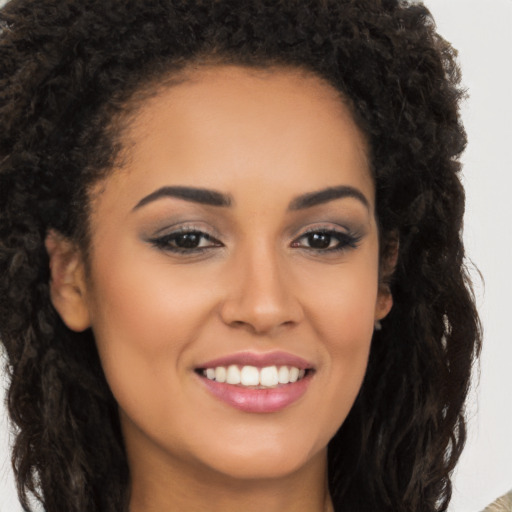 Joyful latino young-adult female with long  brown hair and brown eyes