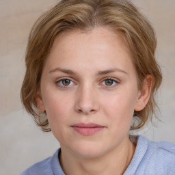 Joyful white young-adult female with medium  brown hair and blue eyes