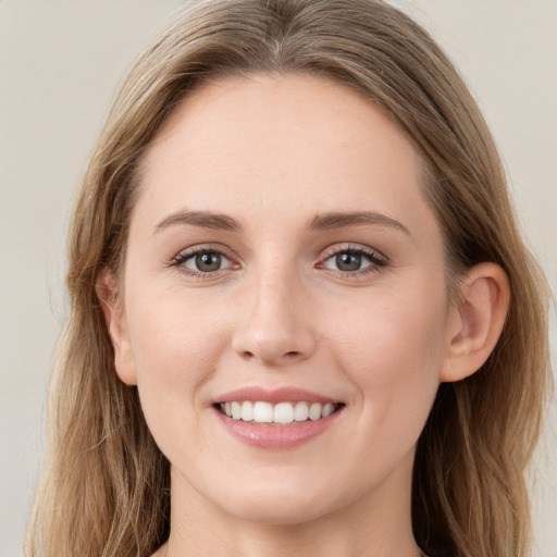 Joyful white young-adult female with long  brown hair and grey eyes