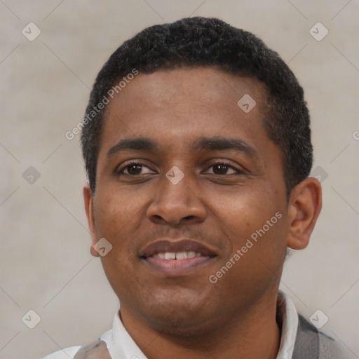 Joyful black young-adult male with short  black hair and brown eyes