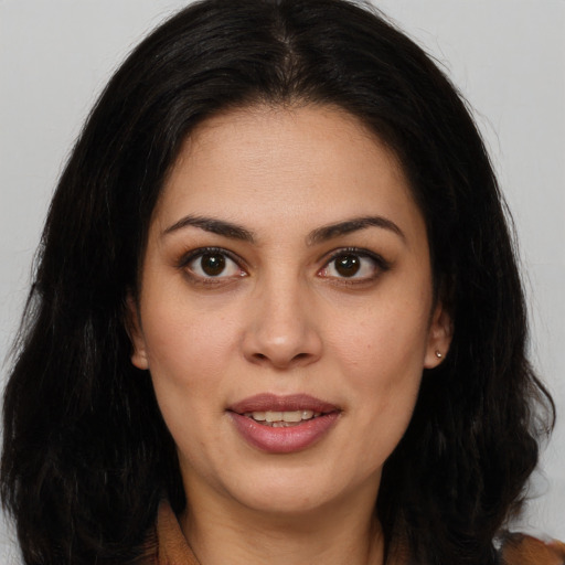 Joyful latino young-adult female with long  brown hair and brown eyes