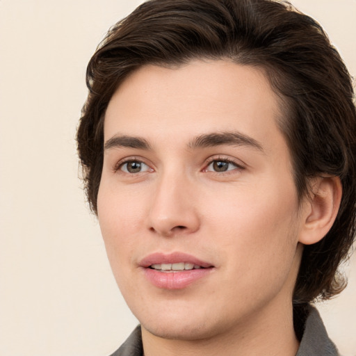 Joyful white young-adult male with medium  brown hair and brown eyes