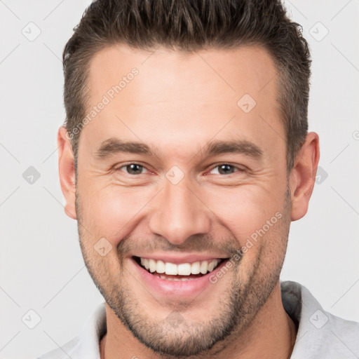 Joyful white young-adult male with short  brown hair and brown eyes