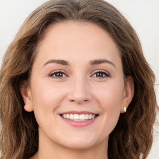 Joyful white young-adult female with long  brown hair and green eyes