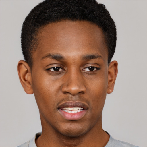 Joyful black young-adult male with short  brown hair and brown eyes