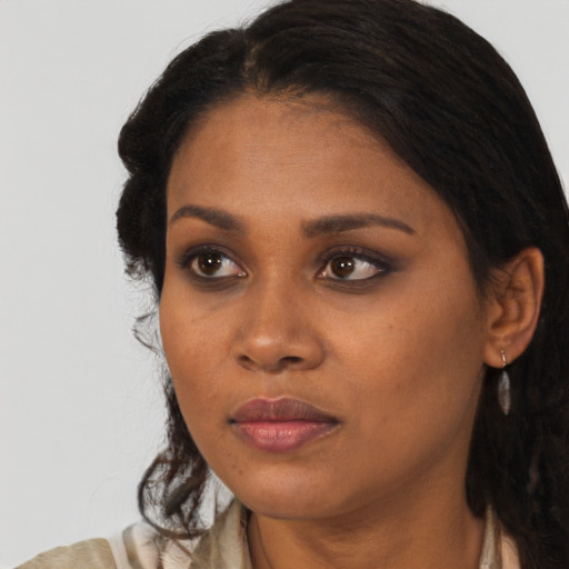 Neutral black young-adult female with long  brown hair and brown eyes