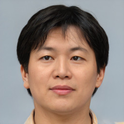 Joyful asian adult female with short  brown hair and brown eyes