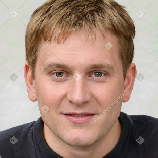 Joyful white young-adult male with short  brown hair and grey eyes