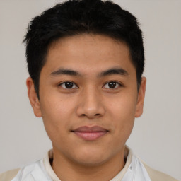 Joyful latino young-adult male with short  brown hair and brown eyes