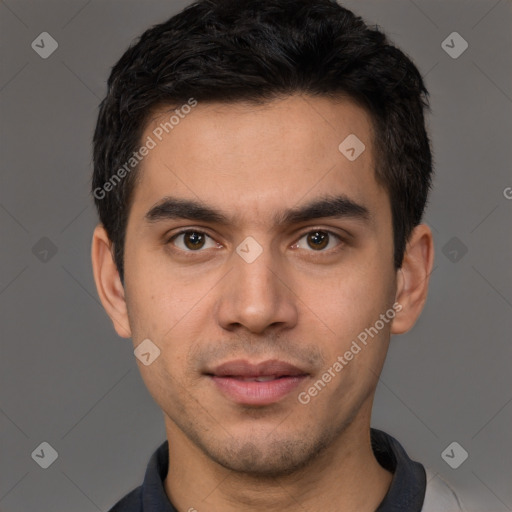 Joyful white young-adult male with short  black hair and brown eyes