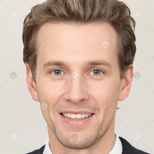 Joyful white young-adult male with short  brown hair and grey eyes