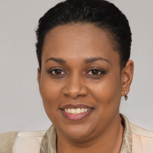 Joyful black young-adult female with short  brown hair and brown eyes