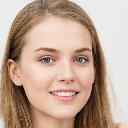 Joyful white young-adult female with long  brown hair and grey eyes