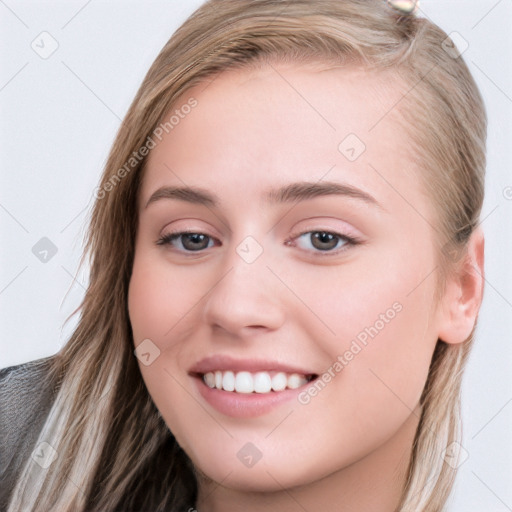 Joyful white young-adult female with long  brown hair and grey eyes