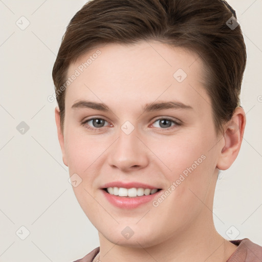 Joyful white young-adult female with short  brown hair and grey eyes