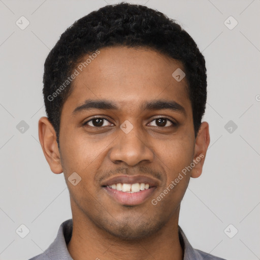 Joyful black young-adult male with short  black hair and brown eyes