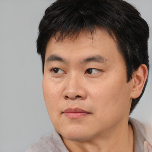 Neutral asian young-adult male with short  brown hair and brown eyes