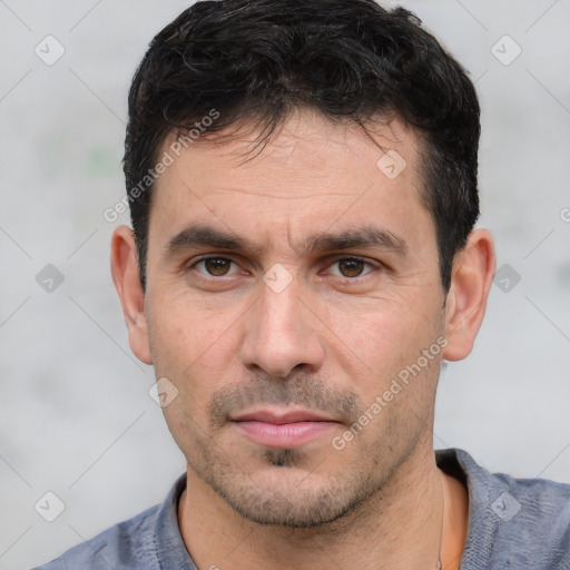 Neutral white adult male with short  black hair and brown eyes