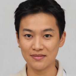 Joyful asian young-adult male with short  black hair and brown eyes