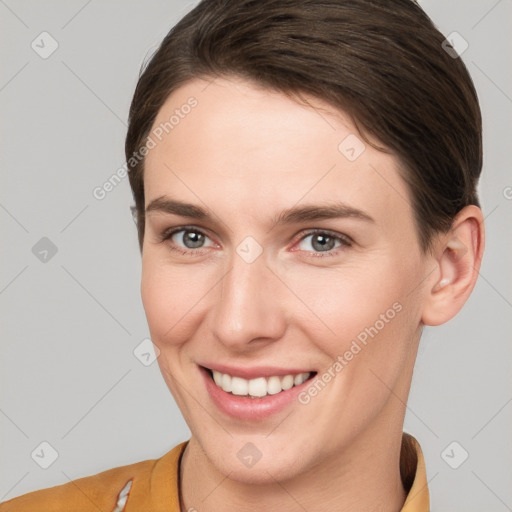 Joyful white young-adult female with short  brown hair and brown eyes