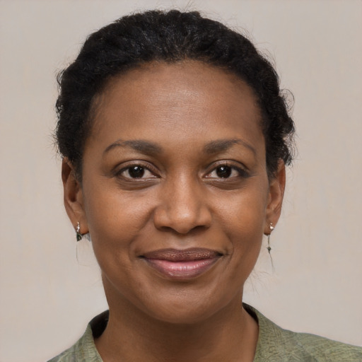 Joyful black adult female with short  brown hair and brown eyes