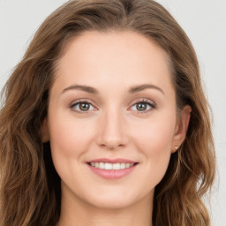 Joyful white young-adult female with long  brown hair and green eyes