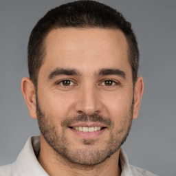 Joyful white young-adult male with short  brown hair and brown eyes