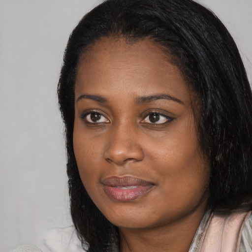 Joyful black young-adult female with medium  black hair and brown eyes