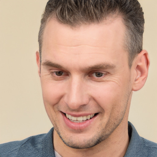 Joyful white adult male with short  brown hair and brown eyes