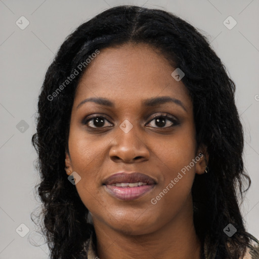 Joyful black young-adult female with long  black hair and brown eyes