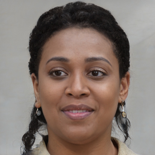 Joyful black young-adult female with medium  black hair and brown eyes