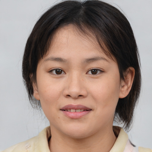 Joyful white young-adult female with medium  brown hair and brown eyes