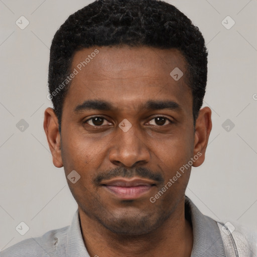 Joyful black young-adult male with short  black hair and brown eyes