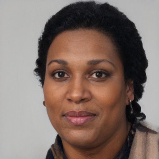 Joyful black adult female with short  black hair and brown eyes