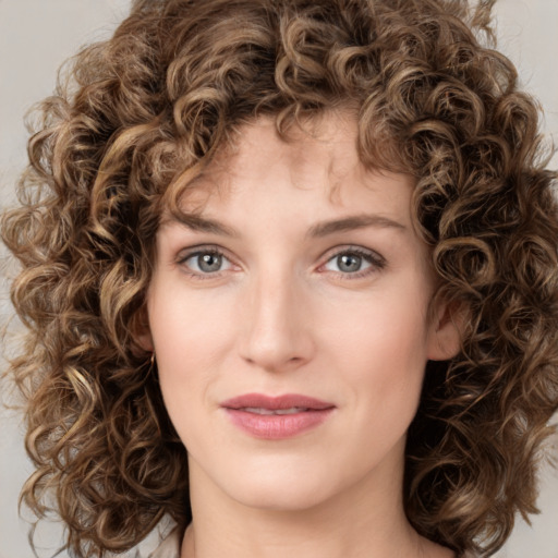 Joyful white young-adult female with medium  brown hair and green eyes