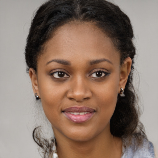 Joyful black young-adult female with medium  brown hair and brown eyes