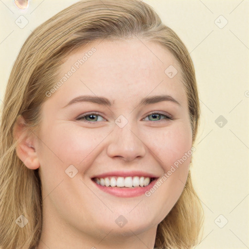 Joyful white young-adult female with long  brown hair and green eyes