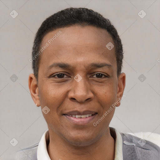 Joyful latino adult male with short  brown hair and brown eyes