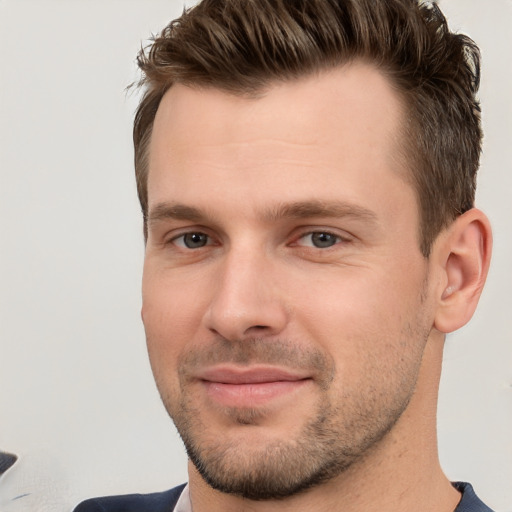 Joyful white young-adult male with short  brown hair and brown eyes