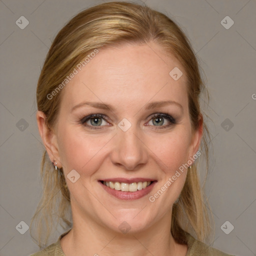 Joyful white adult female with medium  brown hair and blue eyes