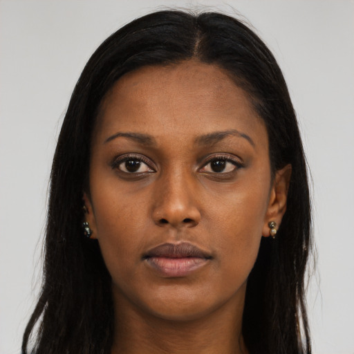 Neutral black young-adult female with long  brown hair and brown eyes