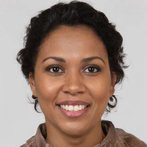 Joyful latino adult female with short  brown hair and brown eyes