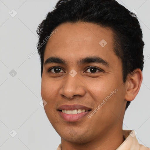 Joyful latino young-adult male with short  black hair and brown eyes