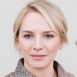 Joyful white young-adult female with medium  brown hair and blue eyes