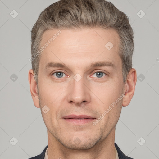 Joyful white adult male with short  brown hair and grey eyes