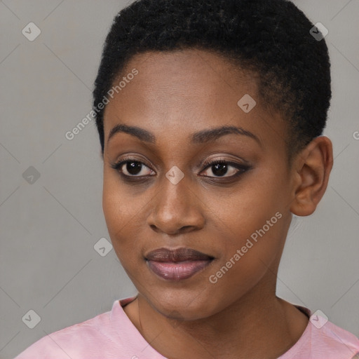 Joyful black young-adult female with short  black hair and brown eyes