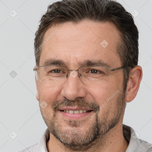 Joyful white adult male with short  brown hair and brown eyes